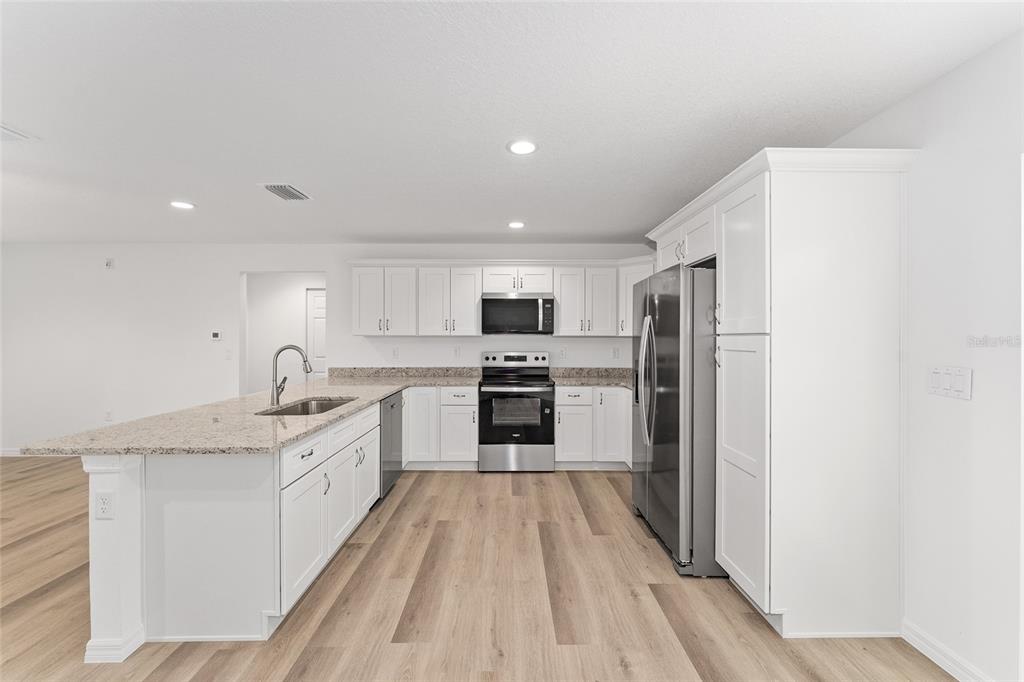 13119 Northeast 7th Loop Silver Springs, FL 34488 - Photo 21 of 51 a large kitchen with a sink stainless steel appliances and cabinets