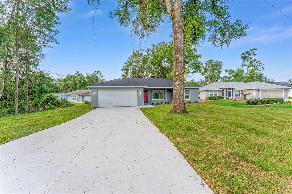 13119 Northeast 7th Loop Silver Springs, FL 34488 - Photo 3 of 51 front view of a house with a yard