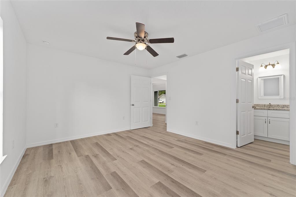 13119 Northeast 7th Loop Silver Springs, FL 34488 - Photo 34 of 51 a view of empty room with wooden floor and window