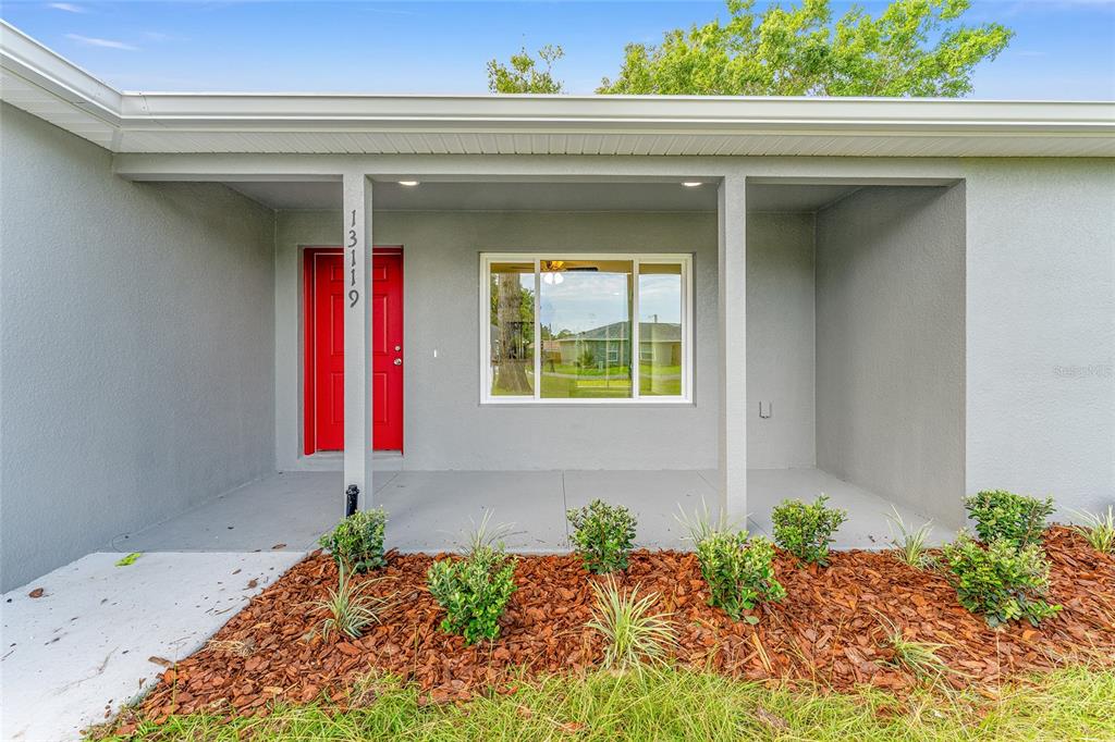 13119 Northeast 7th Loop Silver Springs, FL 34488 - Photo 7 of 51 a front view of a house with entryway
