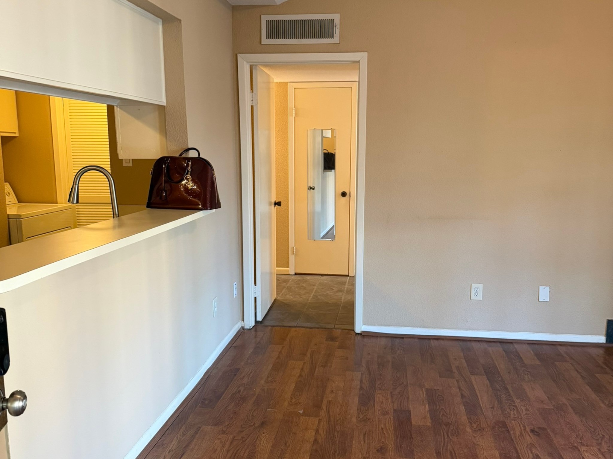 9000 Bissonnet Street, Unit 512 Houston, TX 77074 - Photo 4 of 13 a view of a refrigerator a sink and dishwasher with wooden floor