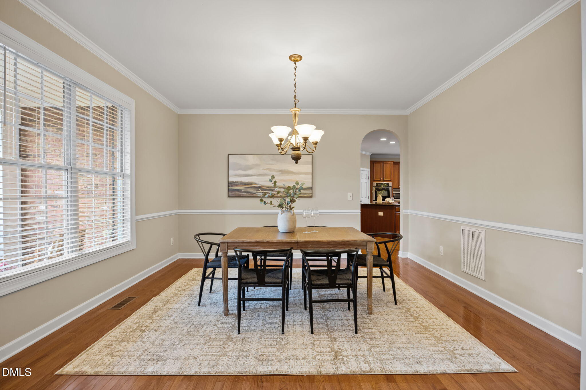 5309 Lyon Farm Drive Durham, NC 27713 - Photo 20 of 68 a dining room with furniture a rug and a chandelier