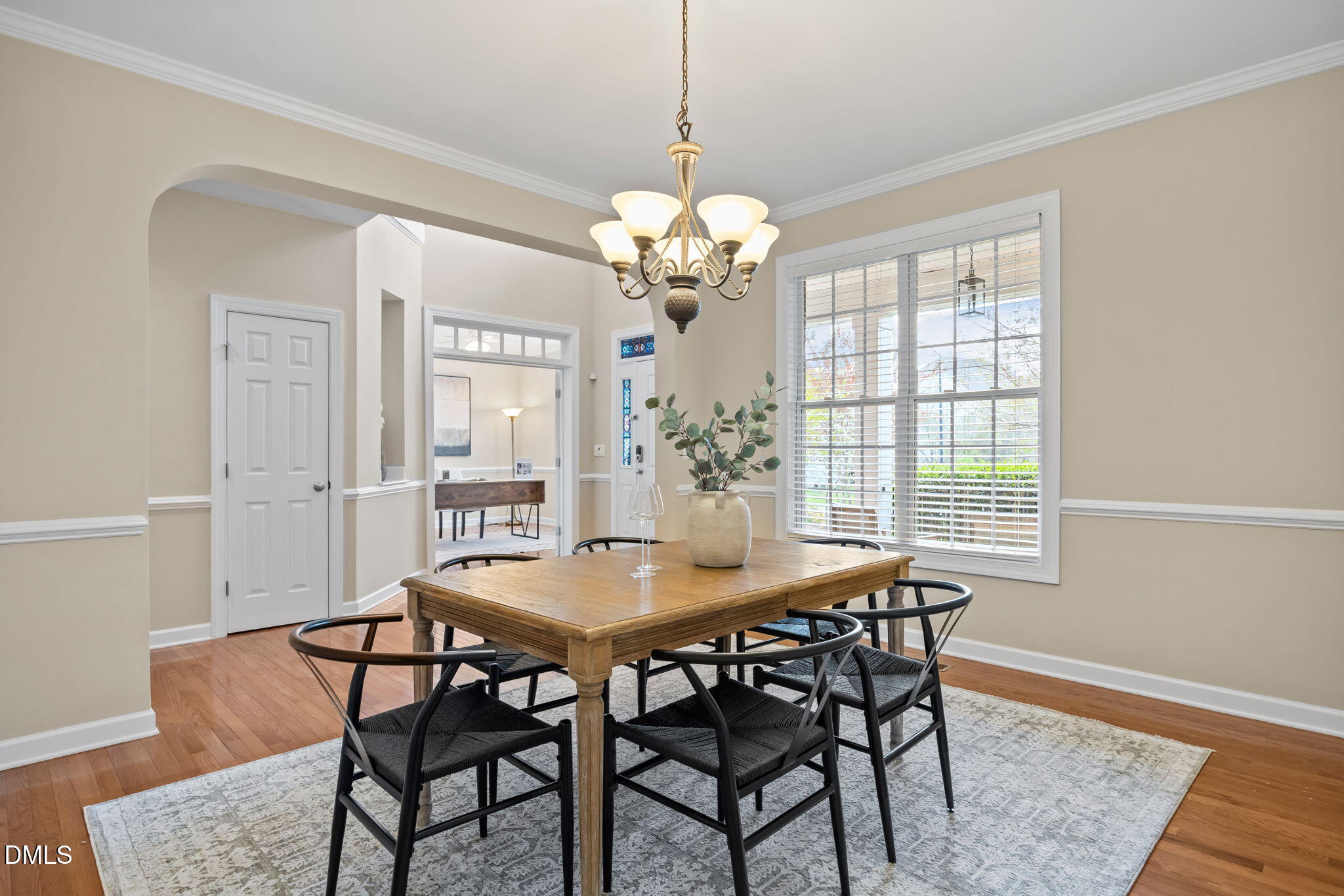 5309 Lyon Farm Drive Durham, NC 27713 - Photo 21 of 68 a dining room with furniture a chandelier and wooden floor