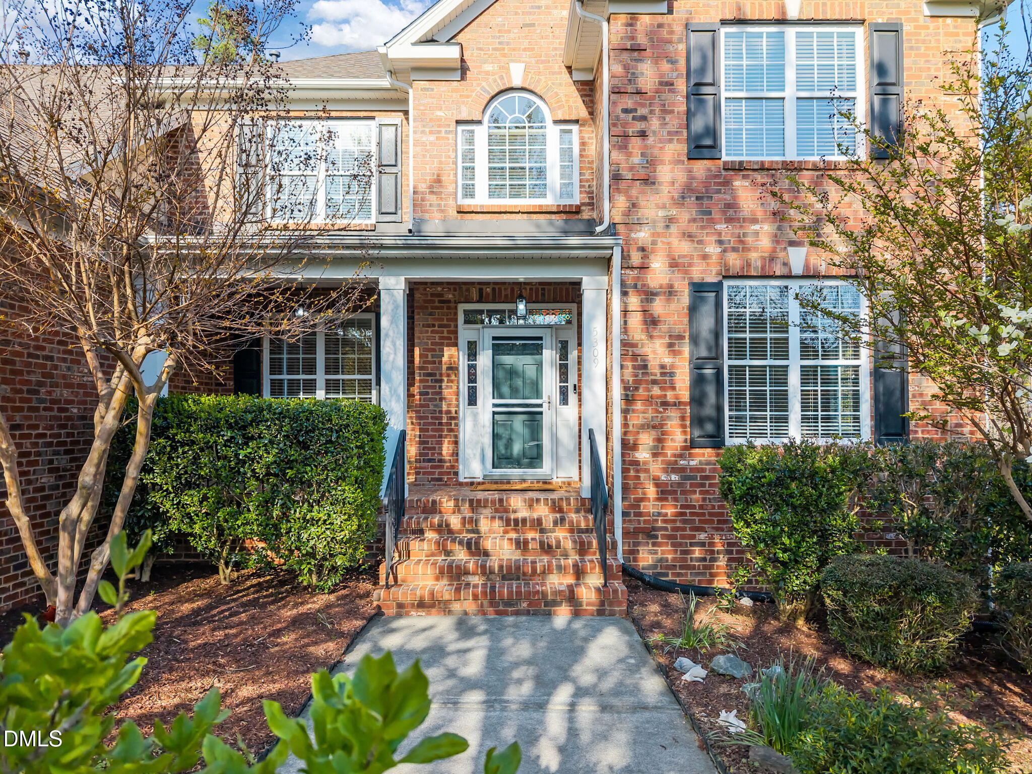 5309 Lyon Farm Drive Durham, NC 27713 - Photo 2 of 68 front view of a brick house with a large window and potted plants