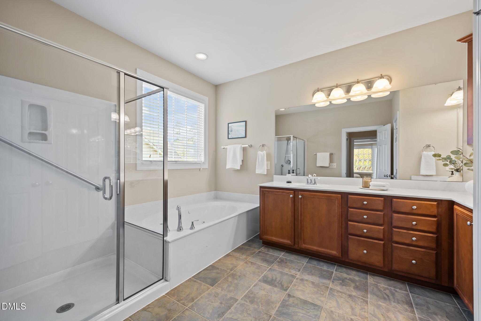 5309 Lyon Farm Drive Durham, NC 27713 - Photo 35 of 68 a spacious bathroom with a tub sink shower and mirror