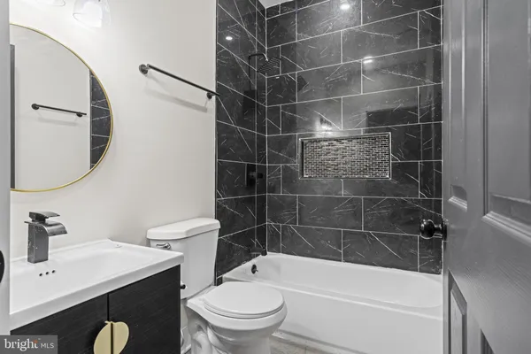 a bathroom with a toilet a sink and bathtub