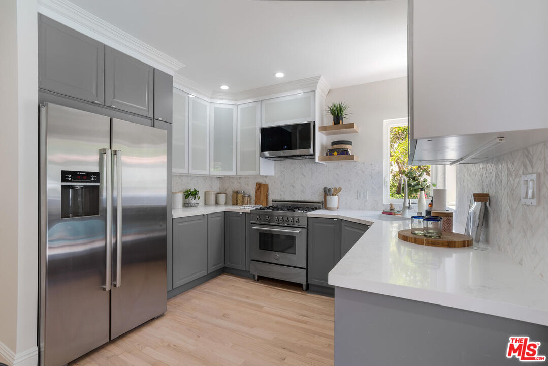 9044 Lloyd Place West Hollywood, CA 90069 - Photo 14 of 35 a kitchen with a refrigerator sink and stainless steel appliances