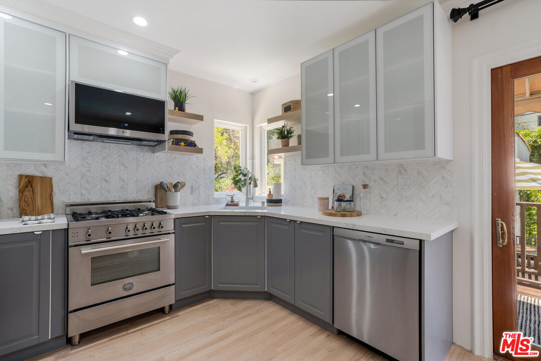 9044 Lloyd Place West Hollywood, CA 90069 - Photo 15 of 35 a kitchen with stainless steel appliances a stove a sink and a microwave