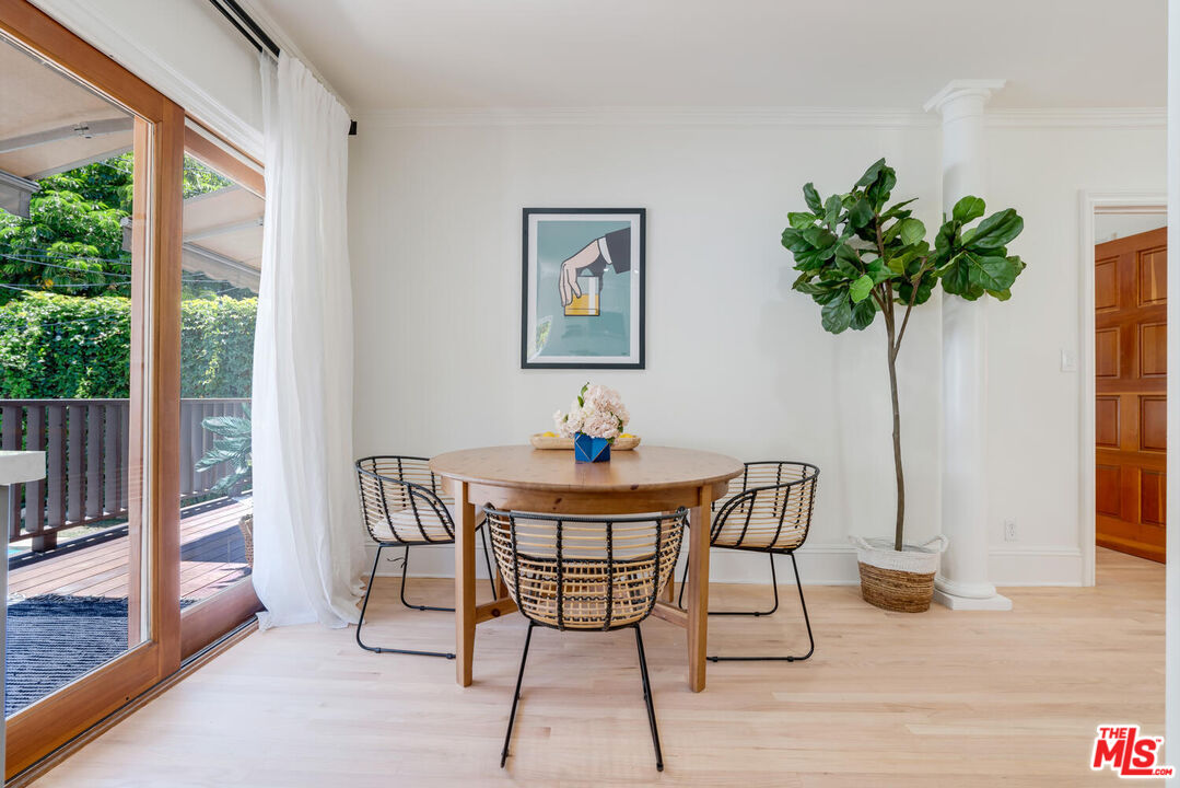 9044 Lloyd Place West Hollywood, CA 90069 - Photo 17 of 35 a view of a dining room with furniture wooden floor and a potted plant