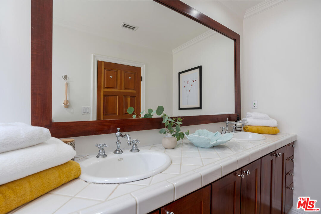9044 Lloyd Place West Hollywood, CA 90069 - Photo 20 of 35 a bathroom with a double vanity sink and a mirror