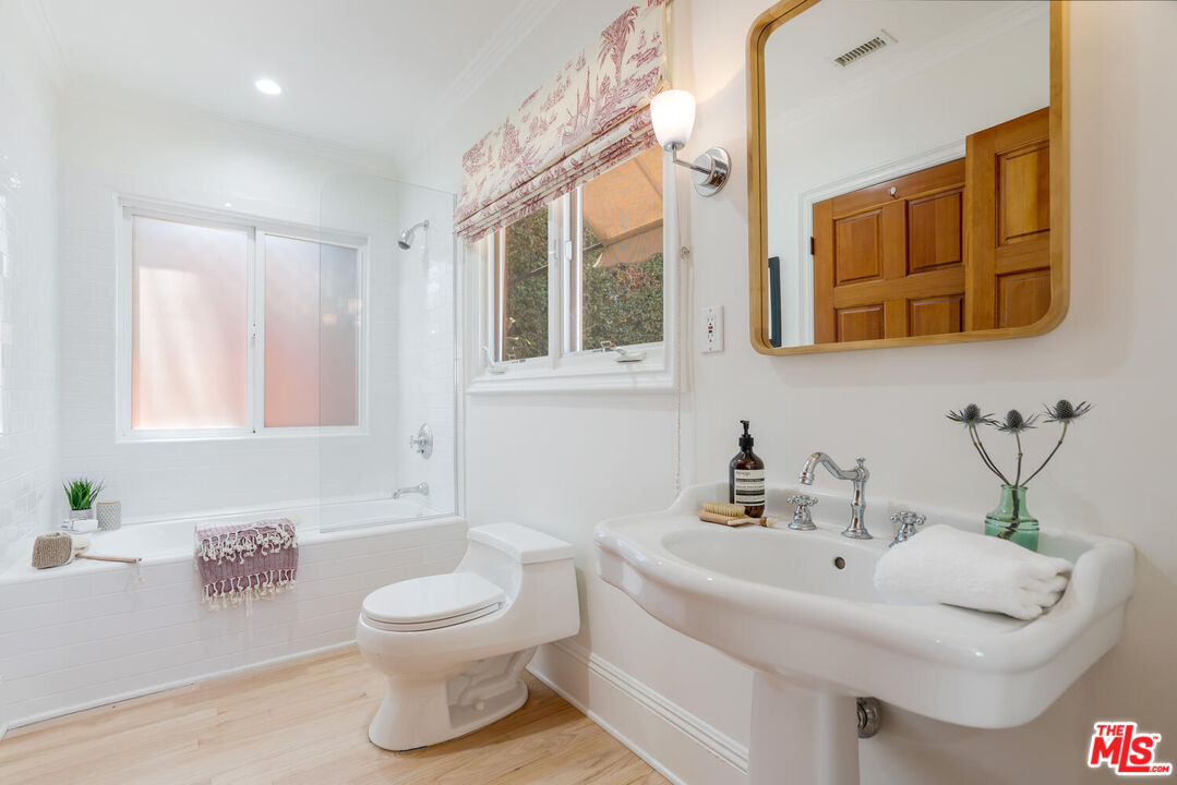 9044 Lloyd Place West Hollywood, CA 90069 - Photo 23 of 35 a bathroom with a toilet sink and mirror