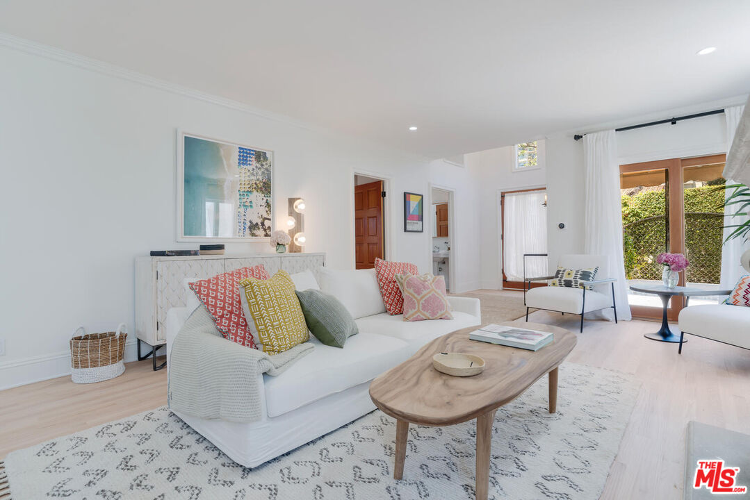 9044 Lloyd Place West Hollywood, CA 90069 - Photo 9 of 35 a living room with furniture a rug and a large window