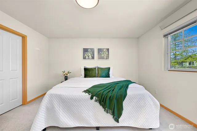 a bedroom with a bed and a window