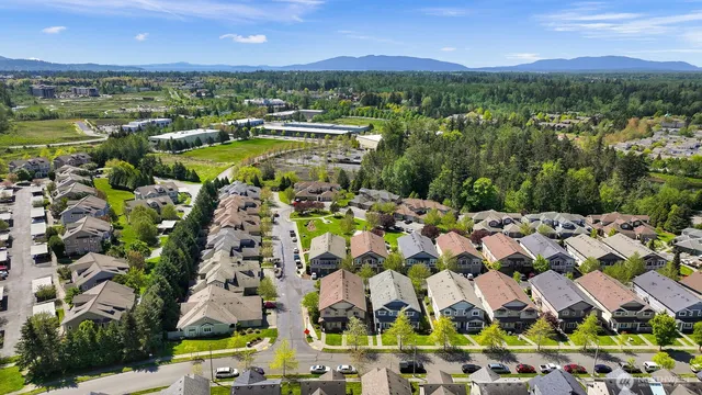 a view of a city with lots of residential buildings ocean and mountain view
