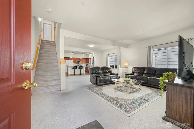 a living room with furniture fireplace and a window