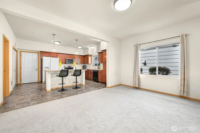 a view of kitchen with furniture and refrigerator