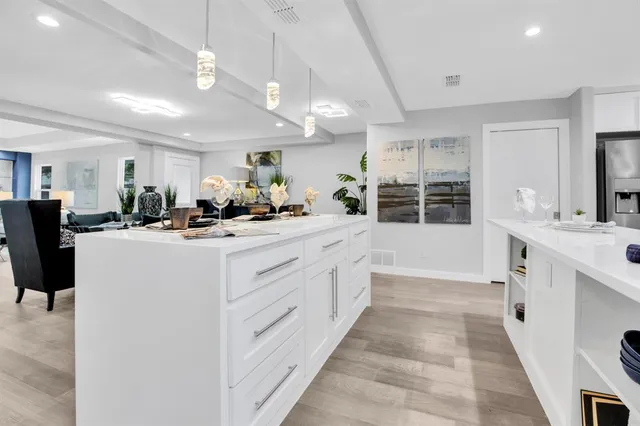 a kitchen with stainless steel appliances kitchen island a sink and cabinets