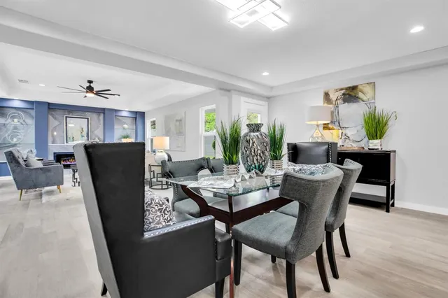 a dining room with furniture a rug and wooden floor