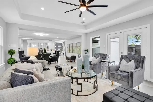 a living room with furniture and a view of kitchen