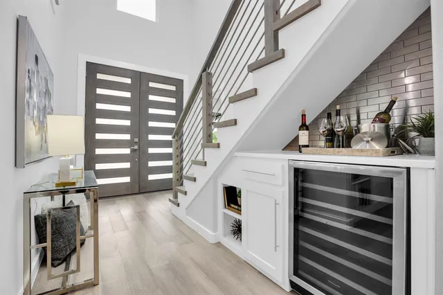 a view of entryway and hall with wooden floor