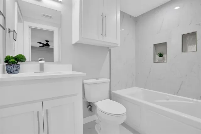 a bathroom with a sink a toilet and bathtub