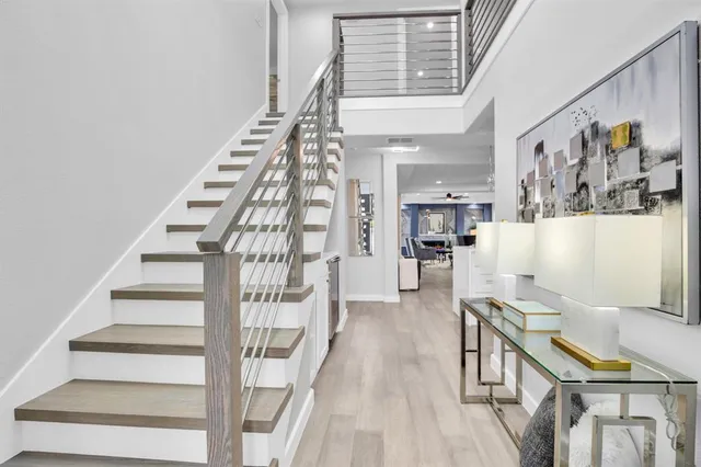 a view of entryway and hall with wooden floor
