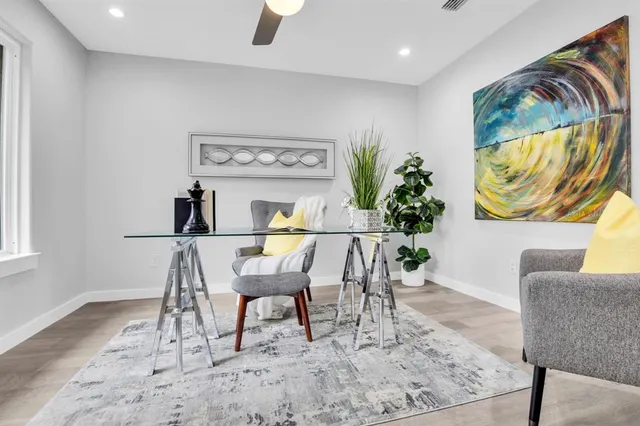 a view of a dining room with furniture and a potted plant