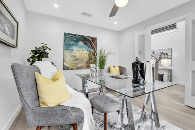 a dining room with furniture and wooden floor