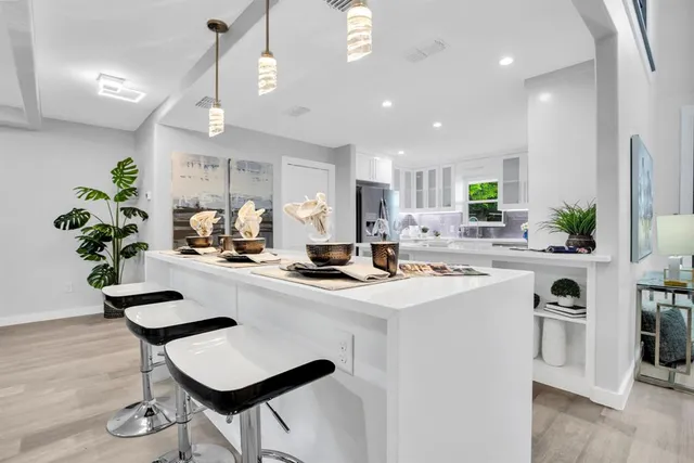 a kitchen with a sink cabinets and wooden floor