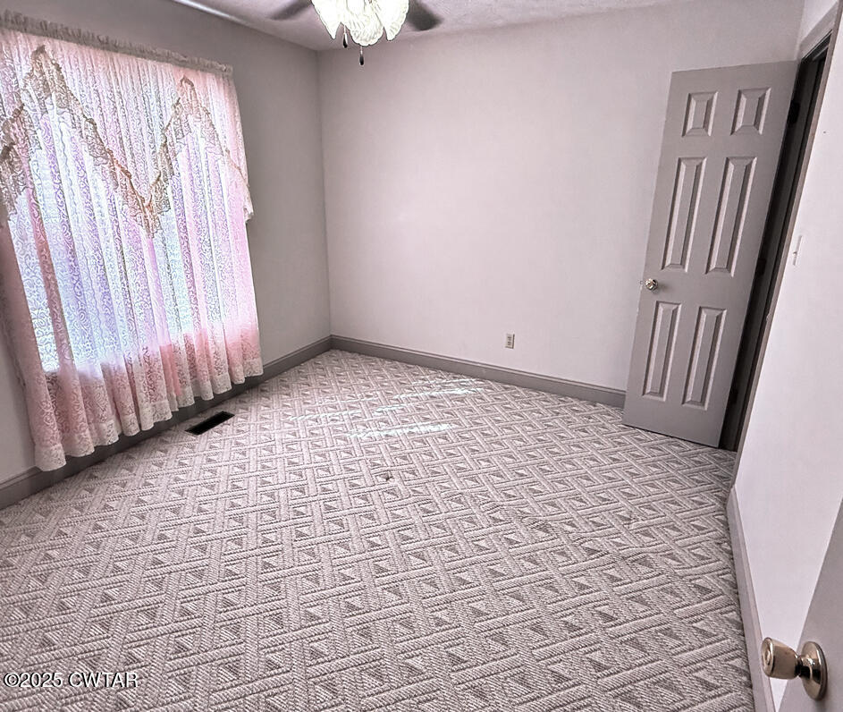 153 Timber Ridge Drive Lexington, TN 38351 - Photo 12 of 29 a view of a bedroom with wooden floor and a window