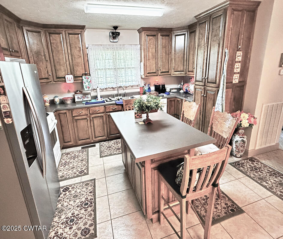 153 Timber Ridge Drive Lexington, TN 38351 - Photo 18 of 29 a kitchen with stainless steel appliances granite countertop a stove a sink dishwasher and a refrigerator