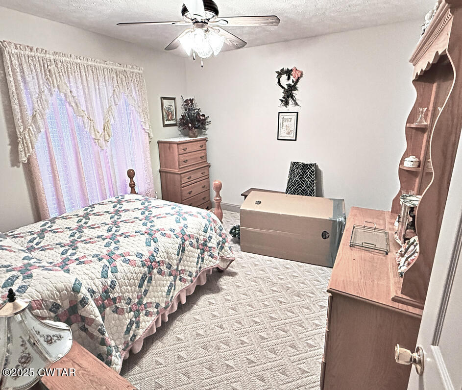 153 Timber Ridge Drive Lexington, TN 38351 - Photo 21 of 29 a bedroom with a bed and a couch