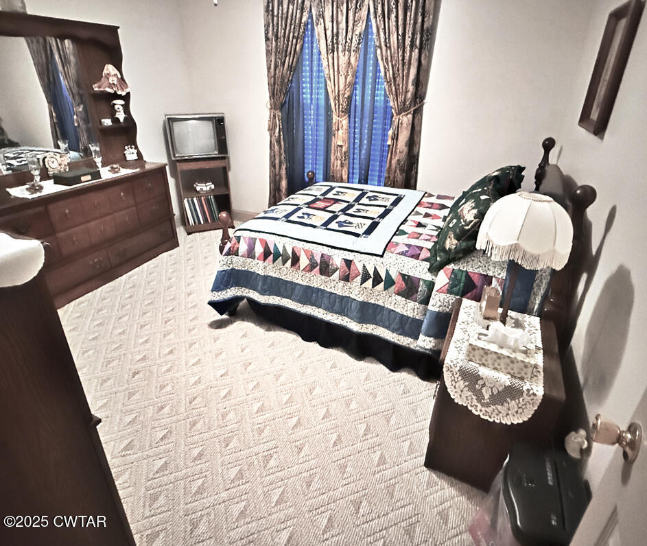 153 Timber Ridge Drive Lexington, TN 38351 - Photo 22 of 29 a bedroom with a bed and dresser with mirror