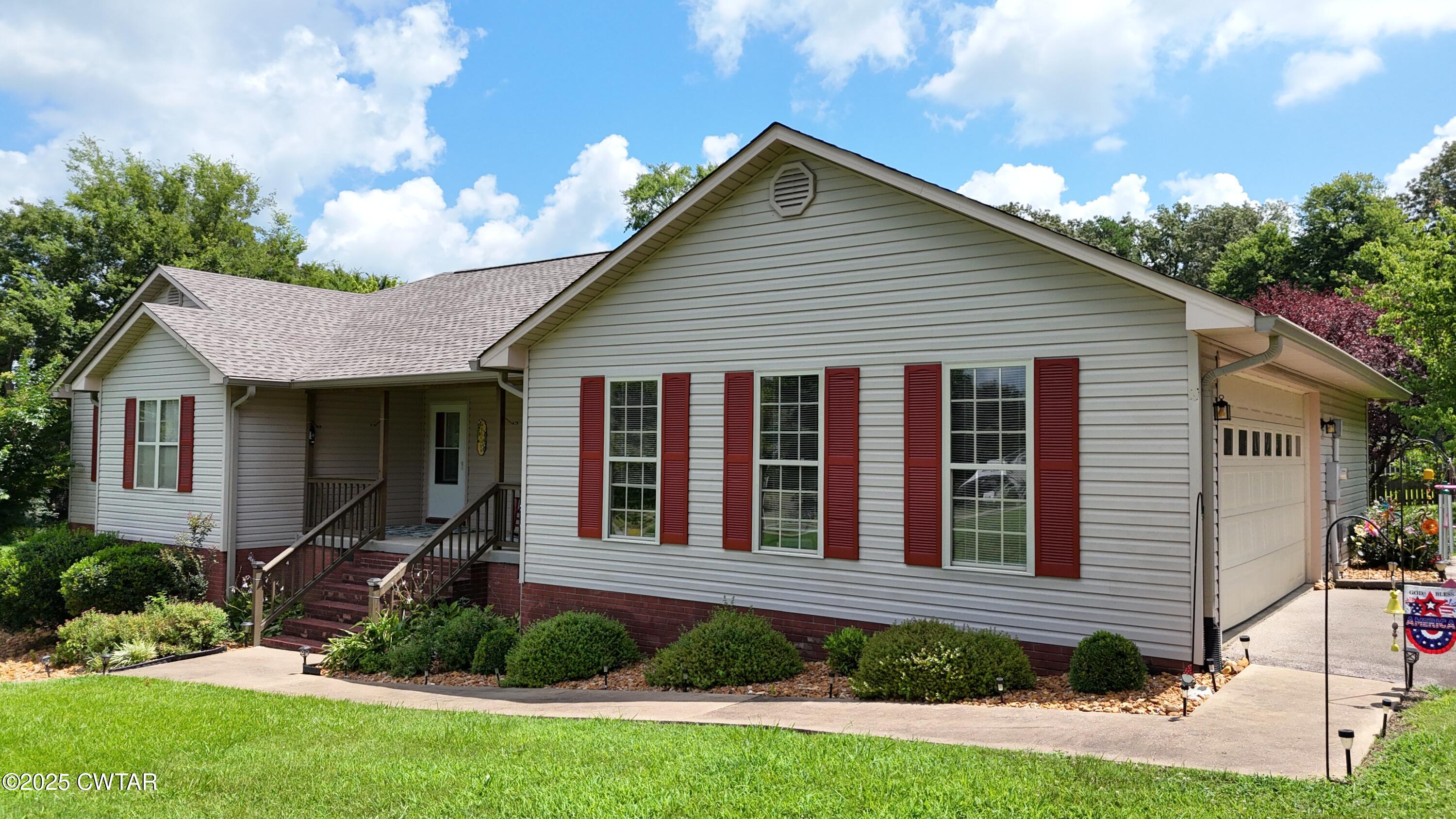 153 Timber Ridge Drive Lexington, TN 38351 - Photo 24 of 29 a front view of a house with a yard and potted plants