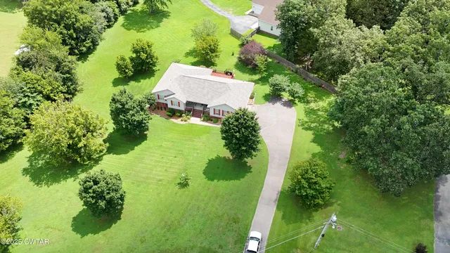an aerial view of a house with a yard