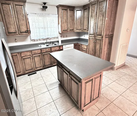 a kitchen with stainless steel appliances cabinets a sink and a window