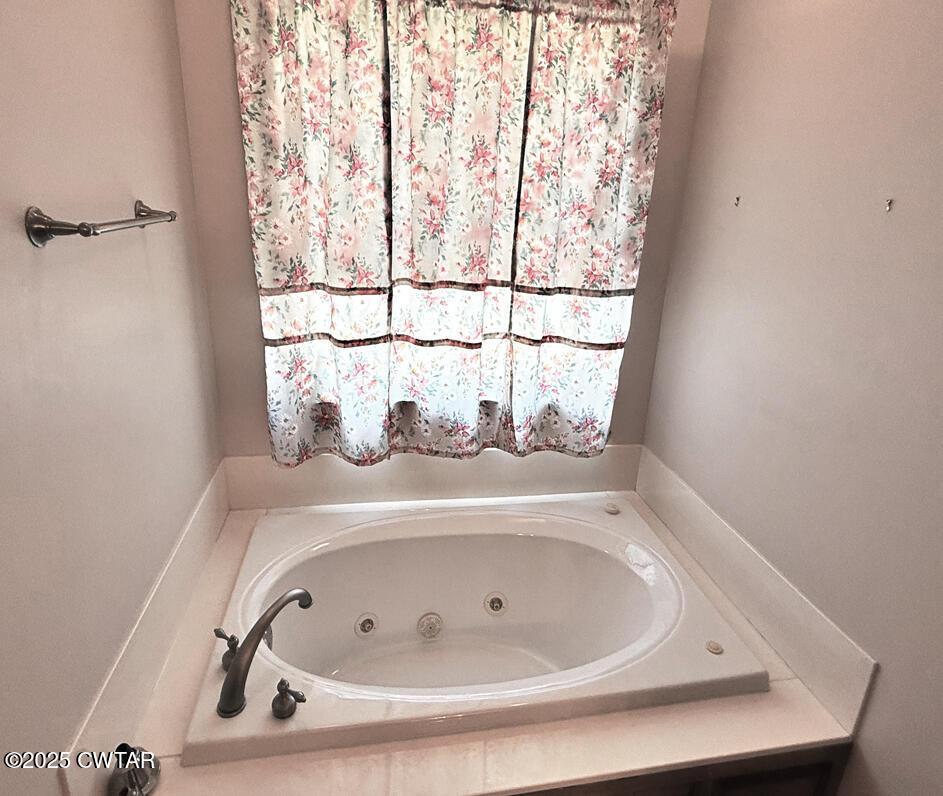 153 Timber Ridge Drive Lexington, TN 38351 - Photo 9 of 29 a bathroom with a tub and window