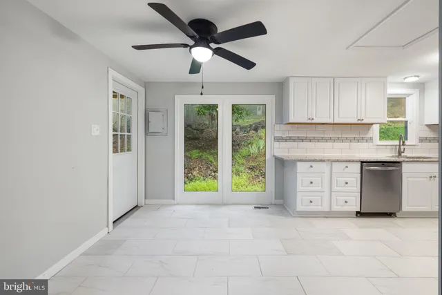 a view of a kitchen with a sink and refrigerator