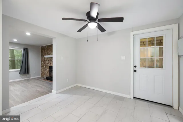 an empty room with a bathroom and a window