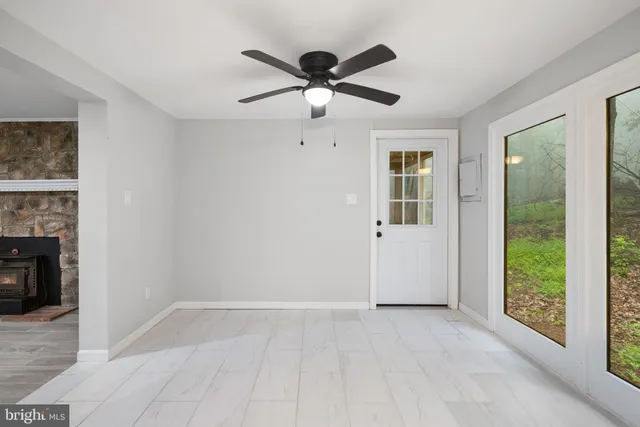 a view of a hallway with wooden floor and entryway