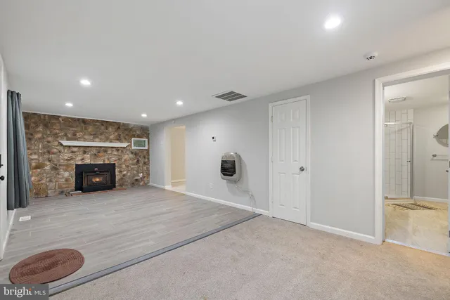 an empty room with windows and closet