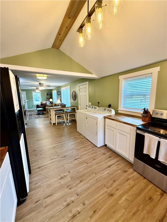 525 Wildcat Bridge Road Royston, GA 30662 - Photo 13 of 26 a large white kitchen with a stove a sink dishwasher and a fireplace with wooden floor