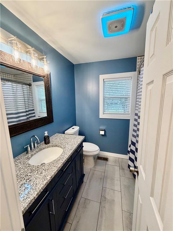 525 Wildcat Bridge Road Royston, GA 30662 - Photo 18 of 26 a bathroom with a granite countertop sink a mirror and a bathtub
