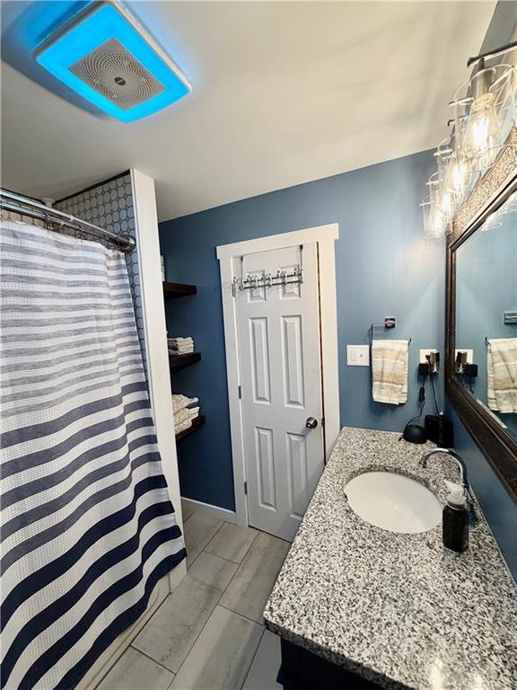 525 Wildcat Bridge Road Royston, GA 30662 - Photo 19 of 26 a en suite bathroom with a granite countertop sink and a mirror