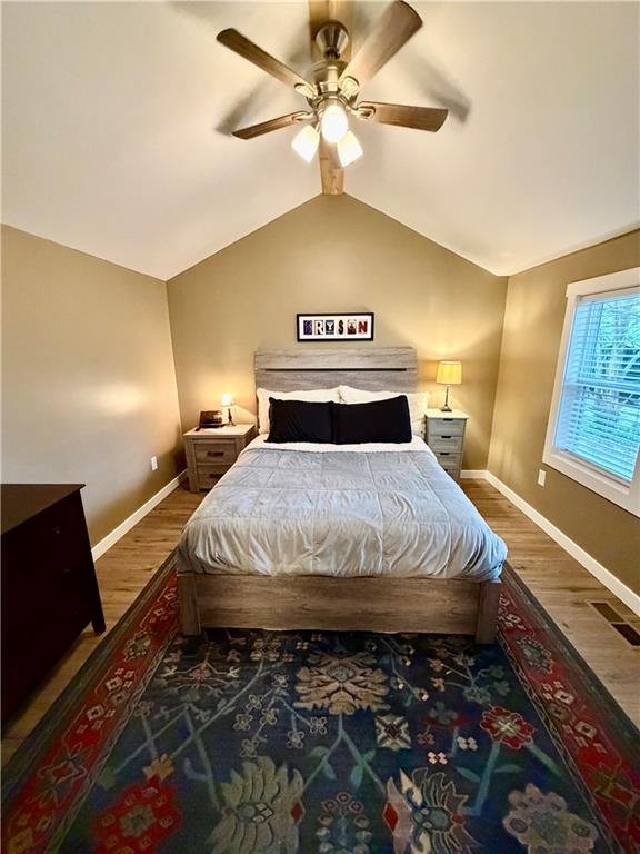 525 Wildcat Bridge Road Royston, GA 30662 - Photo 20 of 26 a bedroom with a bed and a chandelier