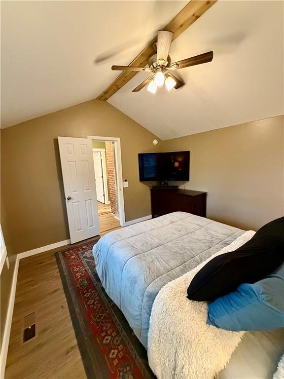 525 Wildcat Bridge Road Royston, GA 30662 - Photo 22 of 26 a bedroom with a large bed and a chandelier