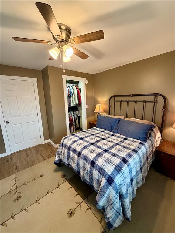 525 Wildcat Bridge Road Royston, GA 30662 - Photo 4 of 26 a bedroom with a bed and ceiling fan