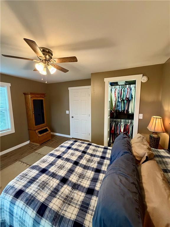 525 Wildcat Bridge Road Royston, GA 30662 - Photo 5 of 26 a bedroom with a large bed and a chandelier