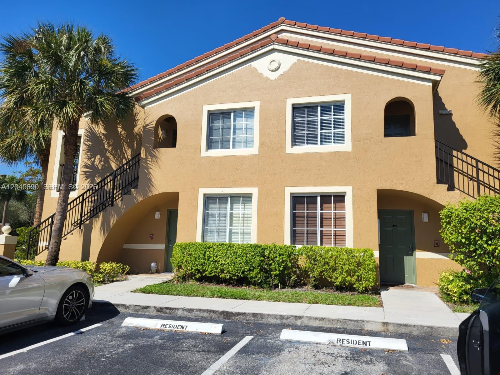 8070 North Nob Hill Road, Unit 208 Tamarac, FL 33321 - Photo 16 of 16 a front view of a house with a yard