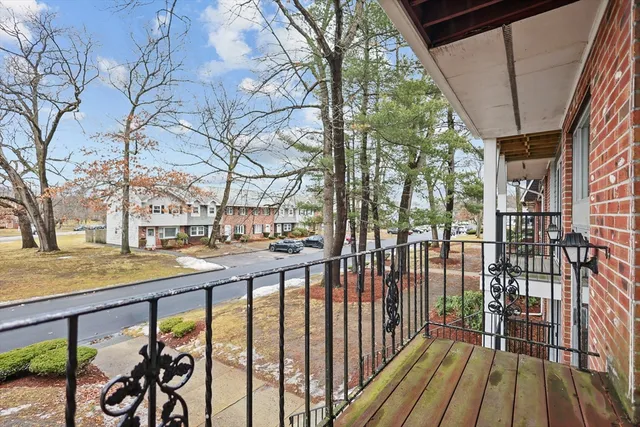 a view of a porch with wooden floor and bench